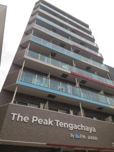 a tall building with the peak tangeragency sign on it at The Peak Tengachaya 605 KIX Direct Cozy Elegance near Namba in Osaka