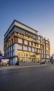 a building on a street in front of a building at The Royal Height in Nawāda