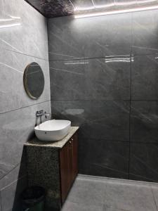a bathroom with a sink and a mirror at The Royal Height in Nawāda +25 photos
