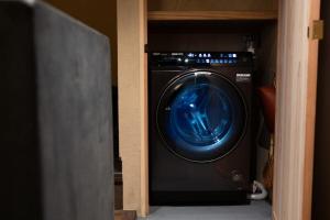 a washing machine sitting inside of a closet at modern villa, asterisk ONOMICHI 2 in Onomichi