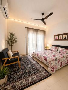a bedroom with a bed and a chair and a window at Eryna Homestay in Nibung Tebal