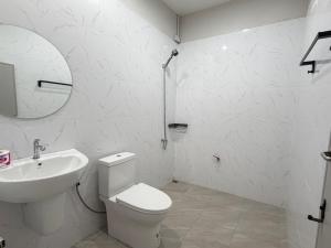 a white bathroom with a toilet and a sink at I mee Lanta Home in Phra Ae beach +11 photos