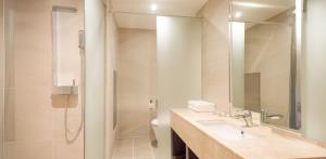 a bathroom with a sink and a shower and a toilet at Venezia Hotel and Suite in Yeosu