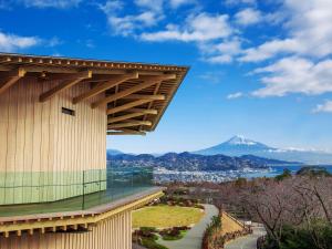 a building with a view of a mountain in the background at Hotel Oak Shizuoka in Shizuoka