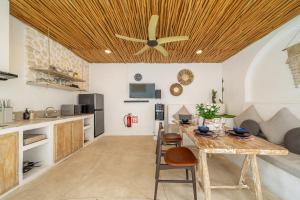 a kitchen with a table and a ceiling fan at Casa Sud - Secluded Pool Villa in Uluwatu in Uluwatu