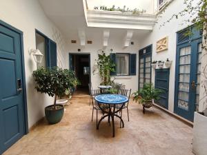 a patio with a table and chairs and plants at Julina Boutique Living in Mosta