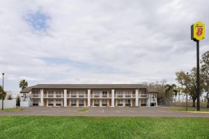 a school building with a parking lot at Super 8 by Wyndham Ellenton Bradenton Area in Ellenton