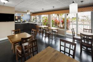 a restaurant with tables and chairs and a bar at Super 8 by Wyndham Ellenton Bradenton Area in Ellenton