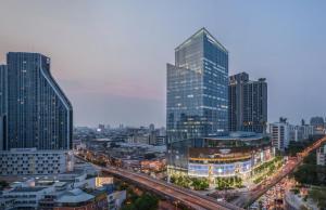 a city skyline with tall buildings and a freeway at Mandarin Hotel Managed by Centre Point in Bangkok