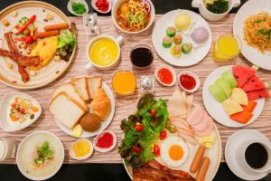 a wooden table with plates of food on it at Mandarin Hotel Managed by Centre Point in Bangkok