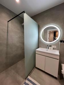 a bathroom with a sink and a mirror at Apartament white Arena in Chişinău