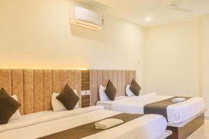 a hotel room with two beds and a heater at HOTEL HIVE in Mājra +39 photos