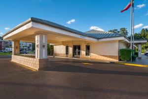 a gas station with a building on a street at Quality Inn & Suites Lufkin in Lufkin