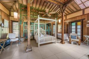a bedroom with a white bed and a ceiling at Rancho Crescent Head in Crescent Head +62 photos