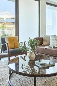 a living room with a couch and a coffee table at Frank Porter - Nara, The Valley in Dubai