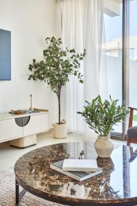 a living room with a table with a book on it at Frank Porter - Nara, The Valley in Dubai +25 photos