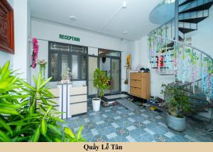 a room with plants and a staircase and a store at Green Homestay in Danang