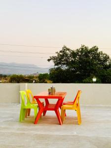 a table and two chairs sitting next to a table at Kohinoor villa in Lonavala