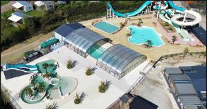 an aerial view of a water park with two pools at Mobilhome moderne avec grande terrasse, pergola, HUDIMESNIL in Hudimesnil