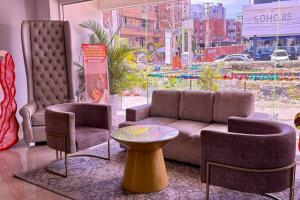 a living room with a couch and two chairs and a table at Radisson Diamond Barranquilla in Barranquilla