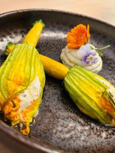 a plate of food with corn and flowers on it at Une chapelle en soie in Taulignan