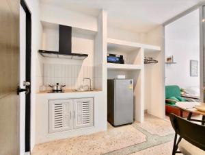 a small kitchen with a refrigerator in a room at 8 Min Walk to IconSiam I BTS near Pier in Bangkok