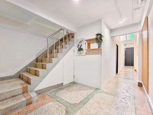 a staircase in a home with white walls and concrete floors at 8 Min Walk to IconSiam I BTS near Pier in Bangkok +10 photos