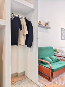 a room with a green chair in a closet at 8 Min Walk to IconSiam I BTS near Pier in Bangkok