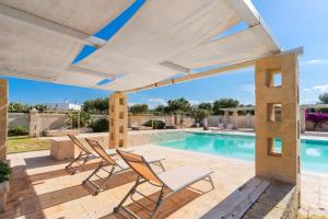 a patio with chairs and a swimming pool at Masseria Capricella in Fasano +34 photos