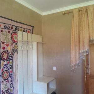 a living room with a staircase and a curtain at Le Fortin in Samarkand