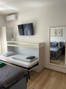 a living room with a bed and a mirror at Salam Sarajevo Apartments #HelloPeace in Sarajevo