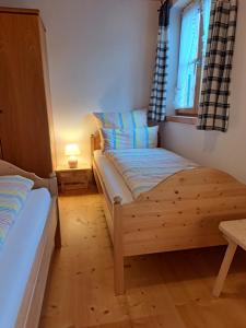a bedroom with two beds and a window at Ferienwohnung Schwarzenberger in Lenggries