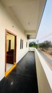 an open door of a white building with a couch at Vishwa Adithya Service Apts in Venkatāpur