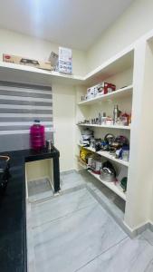 a kitchen with a counter and shelves in a room at Vishwa Adithya Service Apts in Venkatāpur