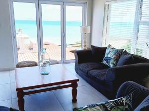 a living room with a couch and a coffee table at Langebaan Beach Towers in Langebaan
