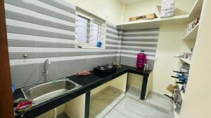 a kitchen with a sink and a counter top at Vishwa Adithya Service Apts in Venkatāpur