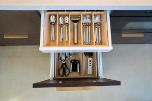 a utensil holder filled with utensils at The Wave Seafront Apartment Vis in Vis +11 photos