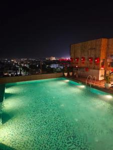 a swimming pool on top of a building at night at Comfort Hotel Vista in Lucknow
