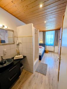 a bathroom with a sink and a bed in a room at Hotel Apartment Das Au- Gut in Hallein +39 photos