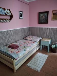 a small bed in a room with a table at Ubytování U Trati in Moravská Nová Ves
