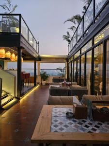 a building with a patio with couches and a table at Comfort Hotel Vista in Lucknow