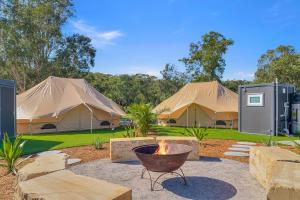 a group of tents with a fire in a yard at Ingenia Holidays Middle Rock in One Mile