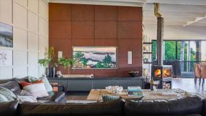 a living room with a couch and a fireplace at Grants - West Cambewarra, Longreach in West Cambewarra