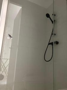 a shower with a shower head in a bathroom at F2 rue fesch in Ajaccio
