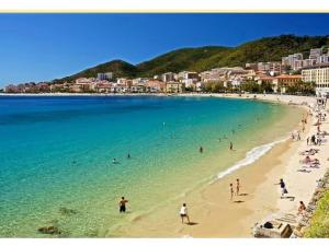 a group of people on a beach in the water at F2 rue fesch in Ajaccio