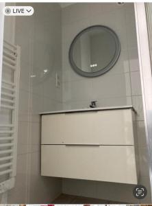 a bathroom with a mirror and a white sink at F2 rue fesch in Ajaccio