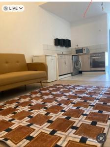 a living room with a couch and a kitchen at F2 rue fesch in Ajaccio
