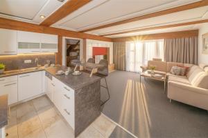 a kitchen and living room with a couch and a table at Hotel Kufsteinerhof in Kufstein
