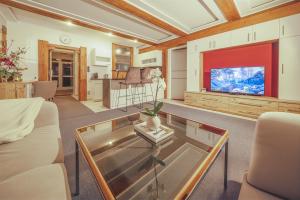 a living room with a couch and a tv at Hotel Kufsteinerhof in Kufstein