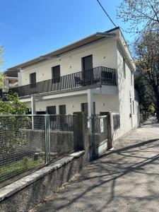 a white building with a fence in front of it at Villa Hajdi Q & U in Merano